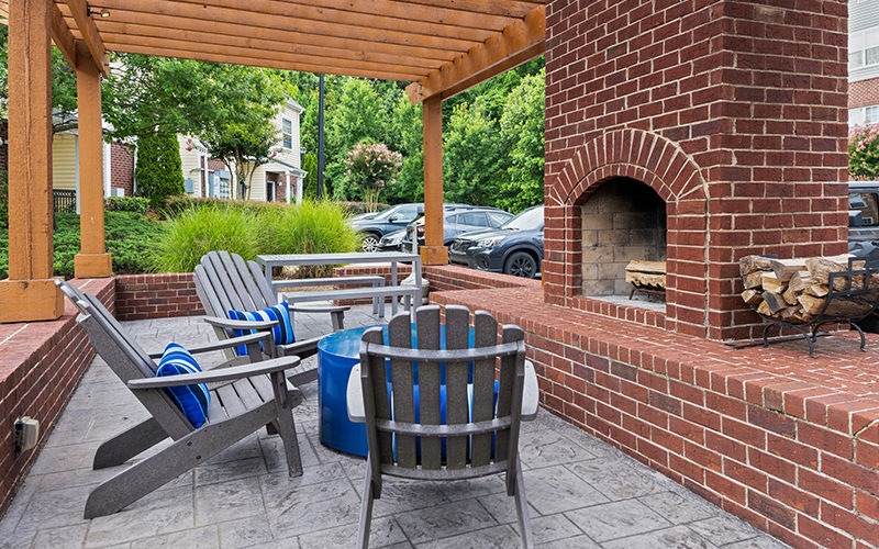 Large outdoor lounge area with a large fireplace
